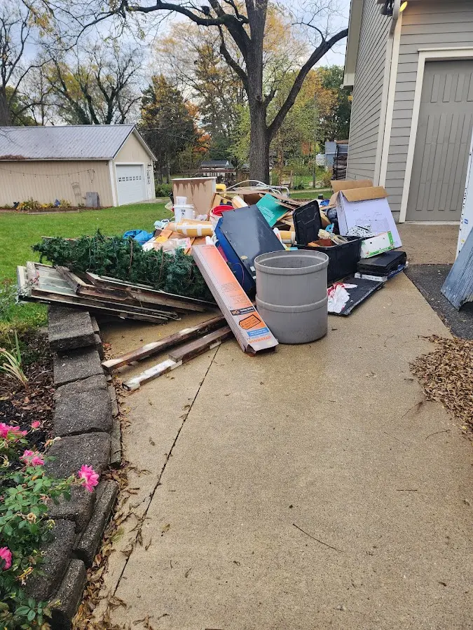 Dumpster being loaded with debris for 12 Yard Dumpster Rental in Avra Valley
